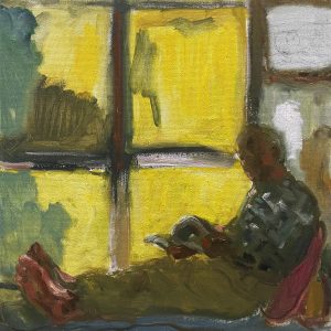 an old man reading a book sitting next to sunny window side.