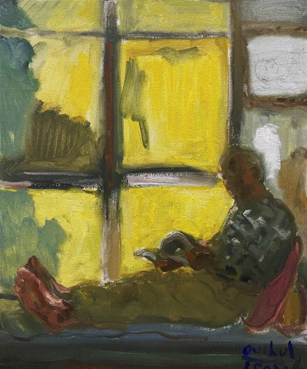 an old man reading a book sitting next to sunny window side.